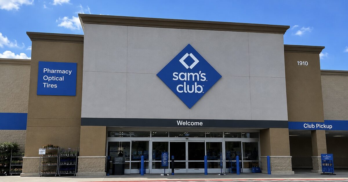 The entrance of a Sam's Club store on a clear day, with signs for the pharmacy, optical center, tires, and Club Pickup