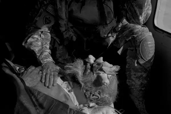 The crew members treat an Afghan man who was injured when his truck rolled over into an irrigation ditch. In addition to responding to wounded American and coalition troops, the medevac units provide care for ordinary Afghans with grave medical conditions.