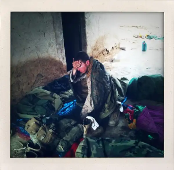 A U.S. Marine wakes up in the morning after sleeping with his platoon in a mud walled compound in Marjah in Afghanistan's Helmand province.