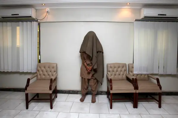 Karachi, Pakistan: An arrested member of the outlawed militant group Lashkar-e-Jhangvi is presented to the media at the Police Crime Investigation Department in Karachi, March 29, 2010. Police had earlier arrested three members of the outlawed Sunni militant group and seized up to 60 kg (132 lbs) of explosives and detonators.