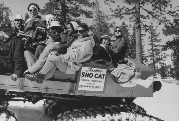 Squaw Valley Olympic athletes ride  The Cripple Cat,  a Sno-Cat meant to transport competitors who happened to get injured during the games.