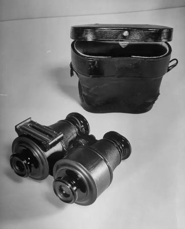 Camera disguised as a pair of binoculars, with one dummy lens.
