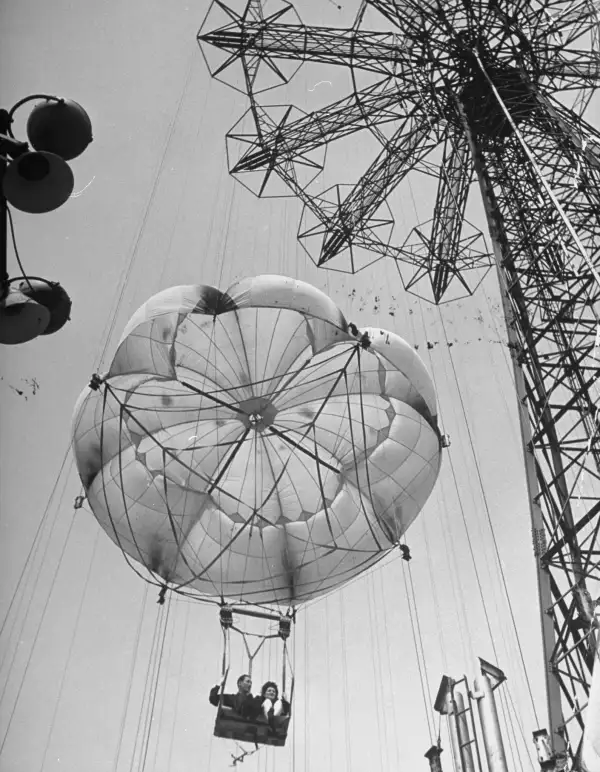 Thrillseekers ride the 300-foot parachute jump at Coney Island.