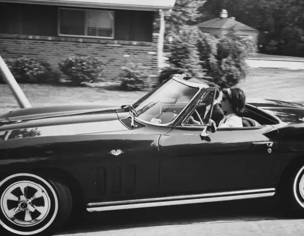 Lucy BainesJohnson rides in her Corvette Sting Ray with a Secret Service agent in the passenger seat.