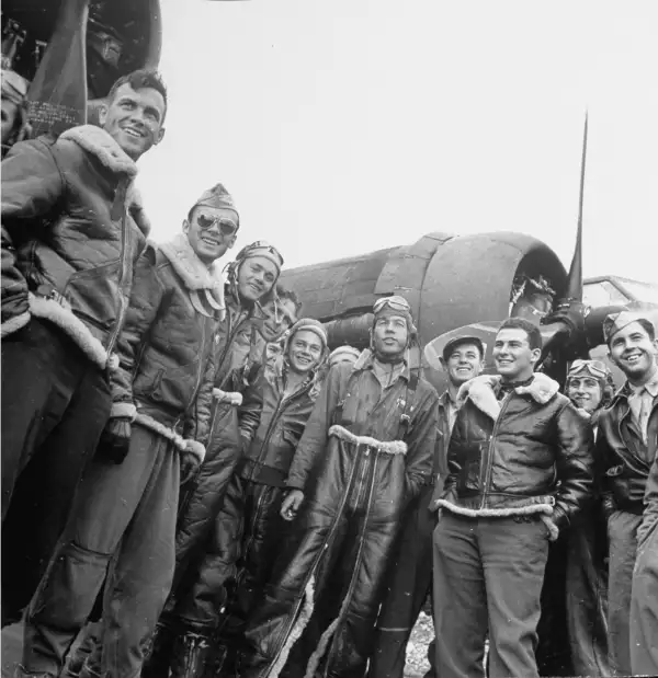 Jubilant B-17 Flying Fortress crew pose after returning unscathed from a bombing raid in September 1942.