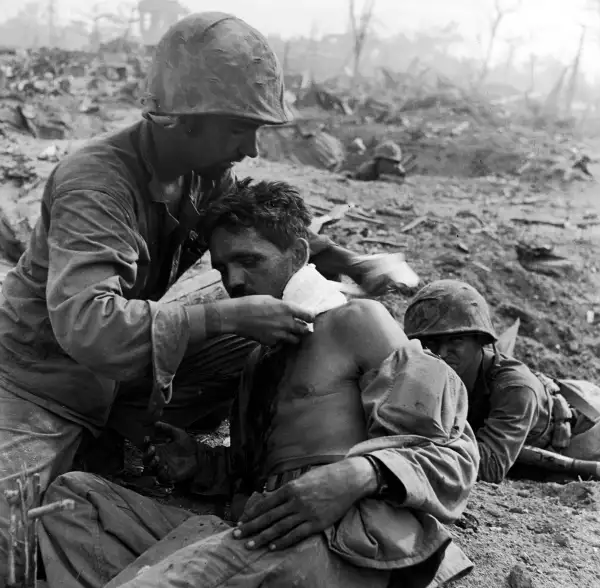 A Medic Treats the Wounded at Tanapag, Saipan
              
              One of Smith's great strengths was an uncanny ability to convey a sense of immediacy even in the most extreme circumstances. Here a U.S. medic field-dresses a wounded serviceman during the month-long battle for Saipan.