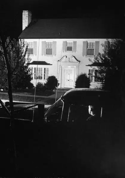 Secret Service agents keeping watch in car outside Richard M. Nixon's home in 1955, during time of Dwight D. Eisenhower's illness, when Nixon was acting President.