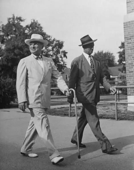President Harry S Truman (left) is matched stride for stride with his Secret Service agent, John Campion.