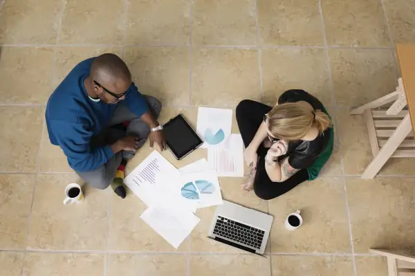 Millenials sitting on the floor discussing 401k investing