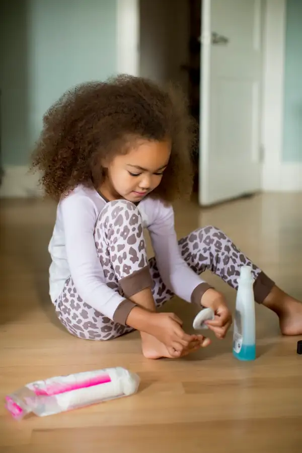 Girl removing nail polish