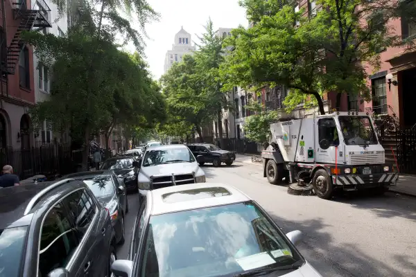 Double-parked cars on an alternate-side parking day