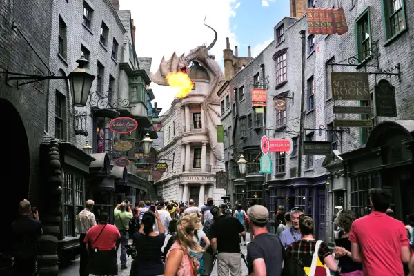 A dragon breathes fire above The Wizarding World of Harry Potter-Diagon Alley during a media preview