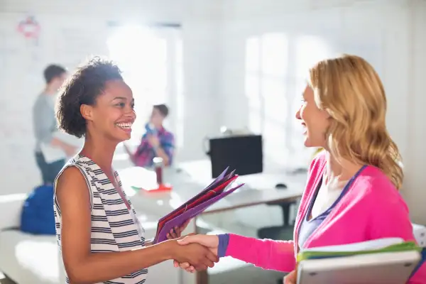 Businesswomen saying hi in an office