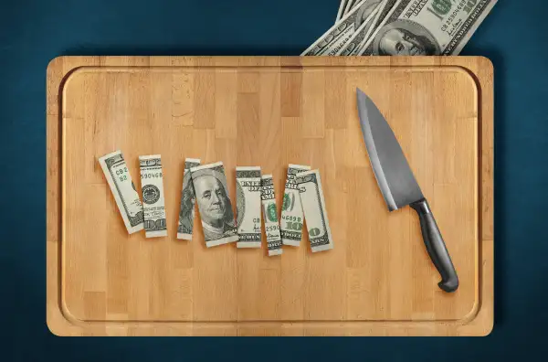 sliced dollar bill on cutting board