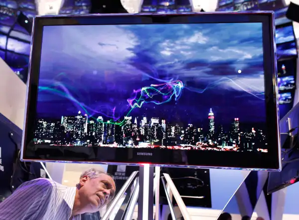 A visitor looks at a Samsung ultraslim plasma flatscreen television.