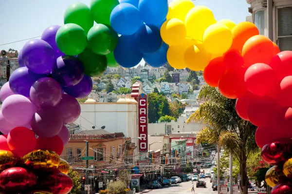 Castro Street in San Francisco is decorated in rainbow flags and balloons for Gay Pride month.