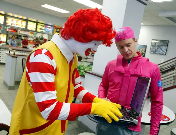 Ronald McDonald on laptop at McDonald's