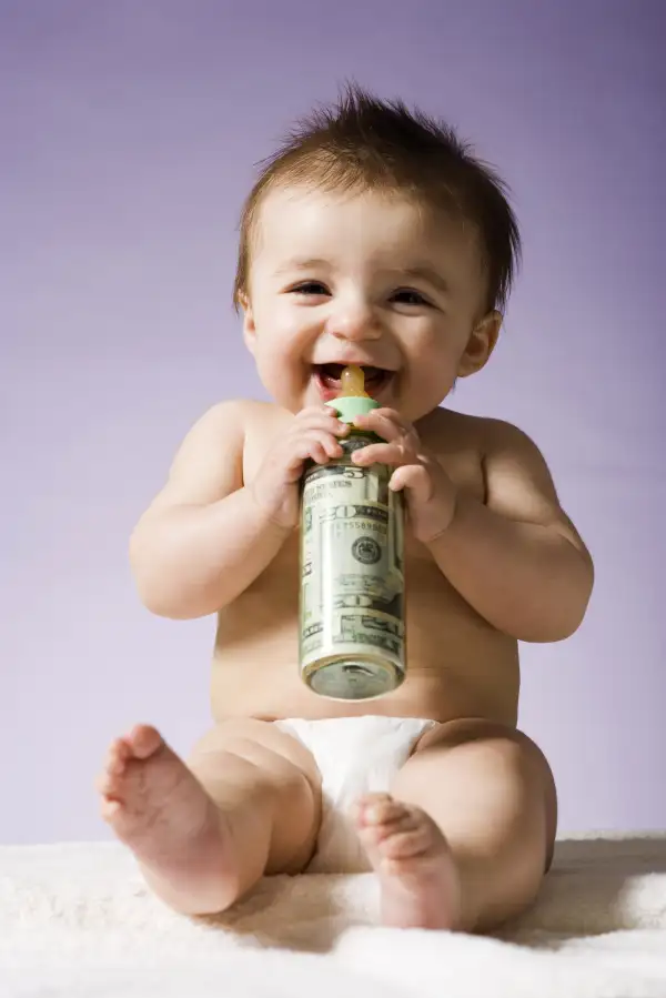 Baby drinking milk bottle filled with cash