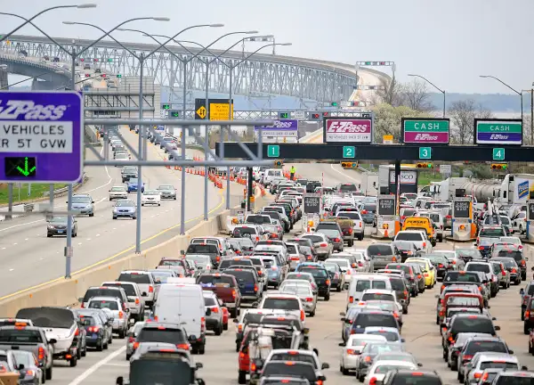 Line of cars waiting up at a toll