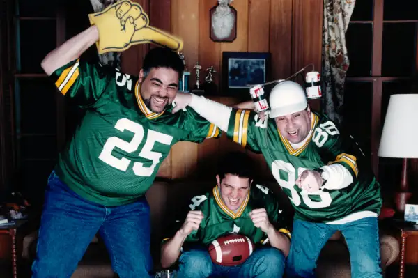 guys on couch cheering for football team