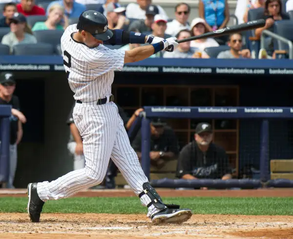 New York Yankees batter Derek Jeter follows through on his swing