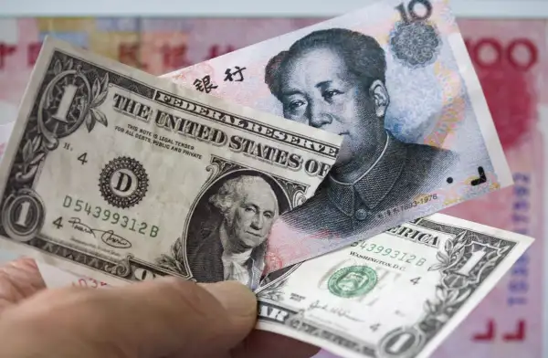 Chinese Yuan banknote plugged into a 1 Dollar banknote.