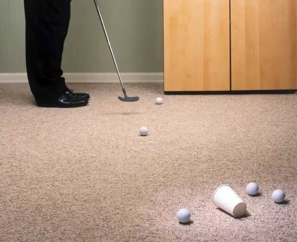 Practicing golf in office