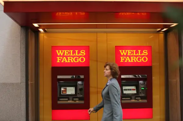 A woman walks past teller machines at a Wells Fargo bank in San Francisco, California.