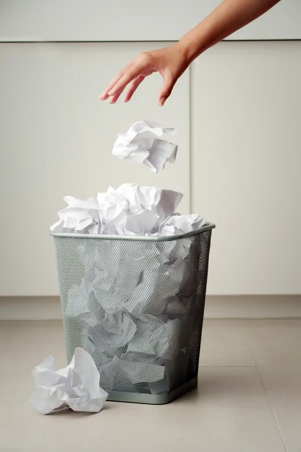 Throwing crumpled paper in wastebasket