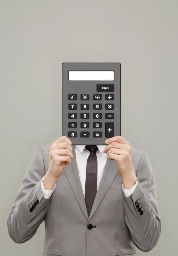 man holding calculator in front of his head
