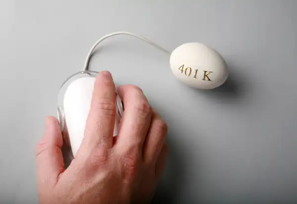hand clicking Apple mouse connected to egg with 401k on it