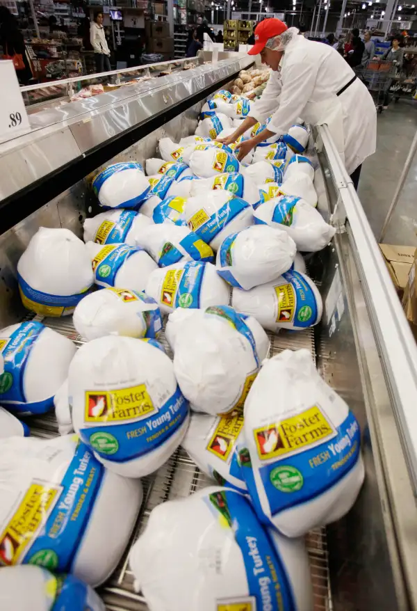 A Costco butcher organizes turkeys for sale at Costco Wholesale in Mountain View, California in preparation for Thanksgiving.