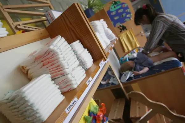 Nappies are piled up on a shelf as nurse