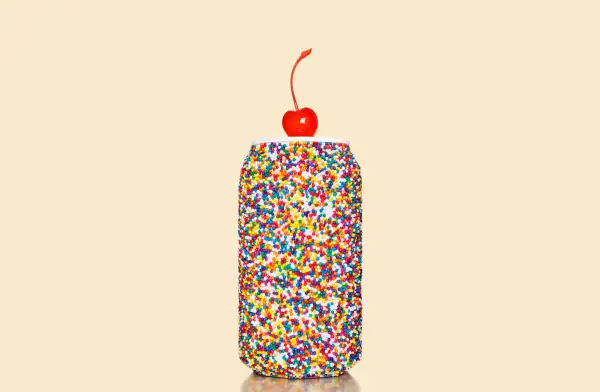 soda can with sprinkles and a cherry on top