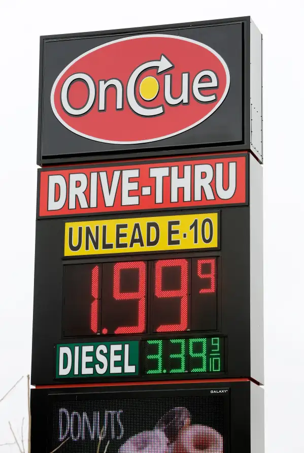 A sign displays the price for E-10 gasoline for $1.99 at the OnCue convenience store and gas station, Wednesday, Dec. 3, 2014, in Oklahoma City.