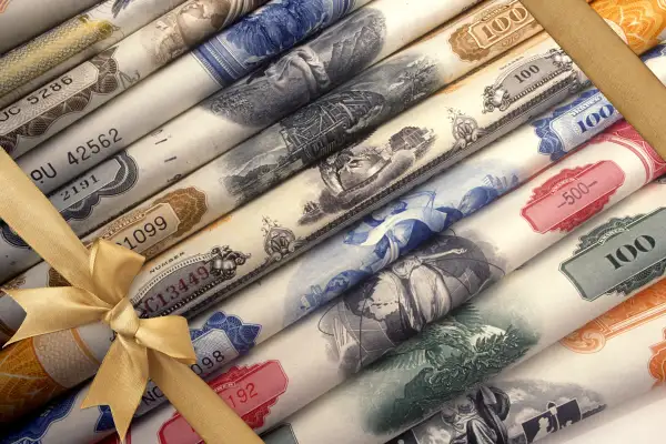 Rolls of stocks with gold bow wrapped around them like a present