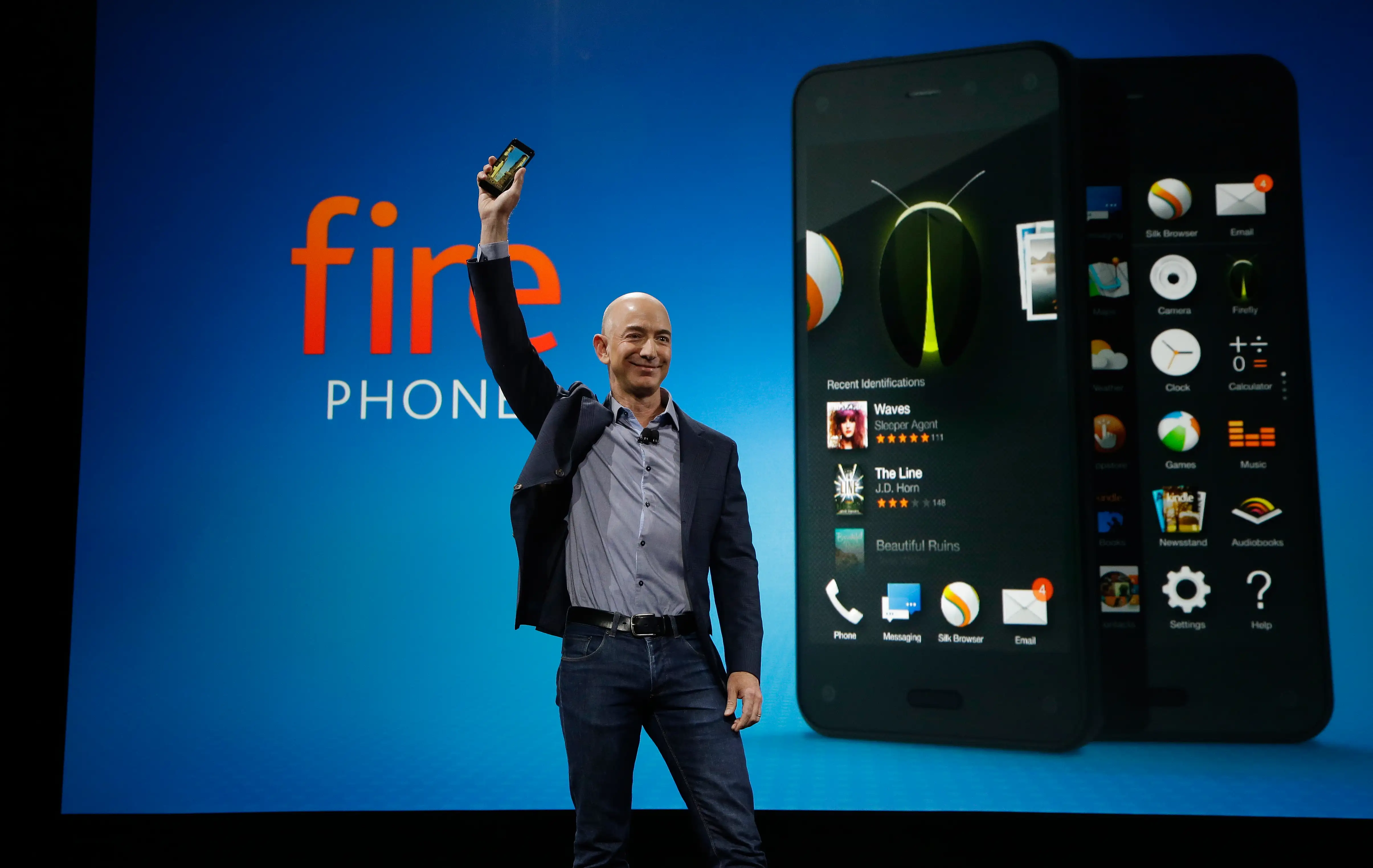 Amazon CEO Jeff Bezos holds up the new Amazon Fire Phone at a launch event, Wednesday, June 18, 2014, in Seattle.