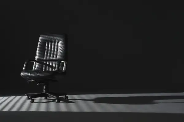 empty office chair in shadows