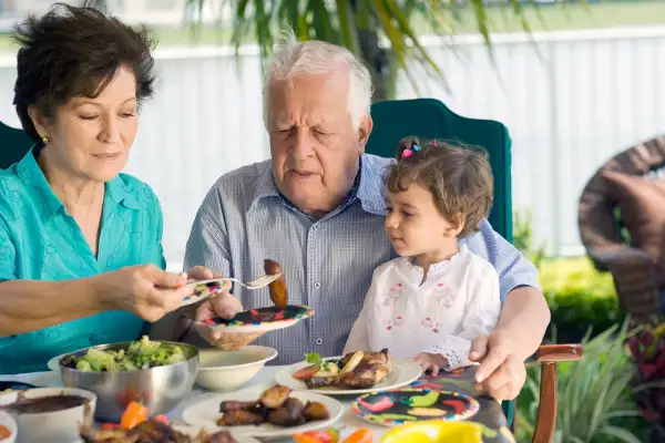 Grandfather at table of food