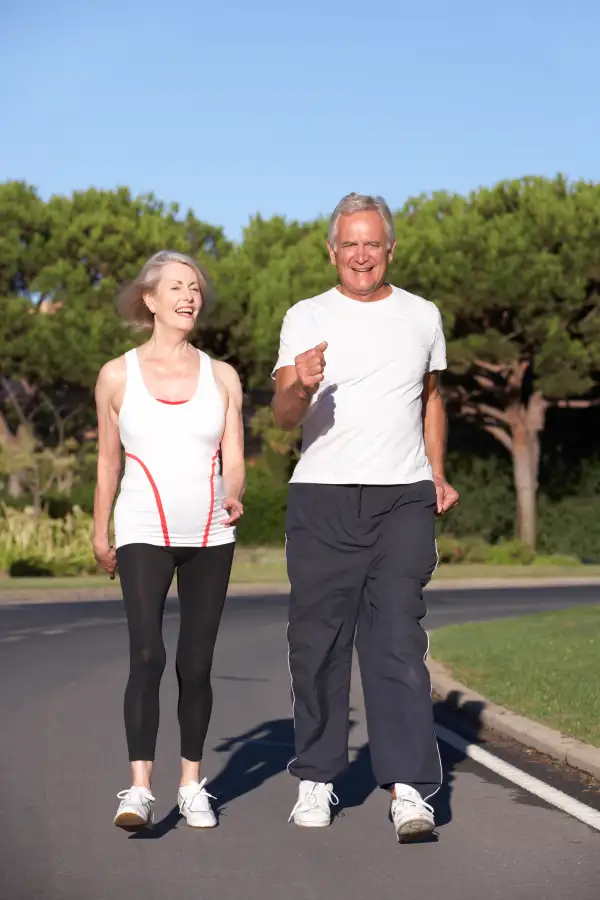 Retirees walking outdoors in sunny weather