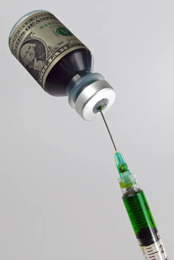 syringe taking liquid from money vial