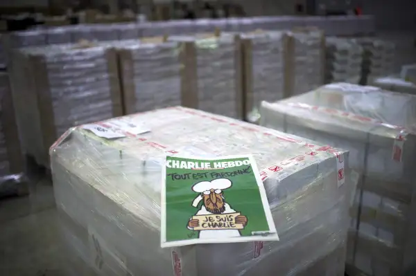 The weekly newspaper Charlie Hebdo, on January 13, 2015 in Villabe, south of Paris, a week after two jihadist gunmen stormed the Paris offices of the satirical magazine, killing 12 people including some of the country's best-known cartoonists. Its cover features the prophet with a tear in his eye, holding a  Je Suis Charlie  sign under the headline  All is forgiven .