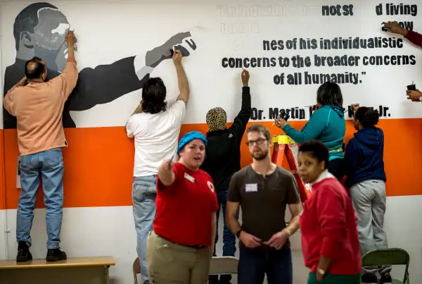 Volunteers paint walls and paint murals all over Coolidge High School during the Martin Luther King Day of Service organized by City Year in honoring the legacy of Dr. King in Washington DC on Monday, January 20, 2014.