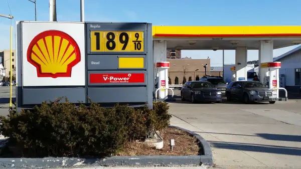 Cars fill up at the pumps at a Shell station near downtown Detroit, where the sign shows the price at $1.899 a gallon on Thursday, Jan. 1, 2015