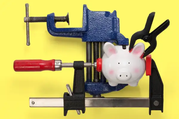 piggy bank in various clamps and a vice