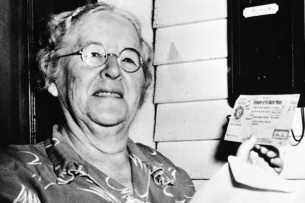 In this Oct. 4, 1950 file photo, Ida May Fuller, 76, displays a Social Security check for $41.30 that she received at her home in Ludlow Vt. On Jan. 31, 1940, Fuller received the country's first Social Security check for $22.54. By the time she died in 1975 at age 100, she had received nearly $23,000 in benefits.