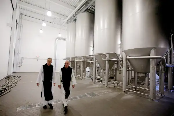 In this Thursday, Jan. 9, 2014 photo, Father Damion, abbot at St. Joseph's Trappist Abbey, left, and Spencer Brewery director Father Isaac walk through their new, state-of-the-art facility in Spencer, Mass. The Spencer Brewery began brewing Spencer Trappist Ale recently becoming only the ninth certified brewery of Trappist beers in the world and the only one outside of Europe.