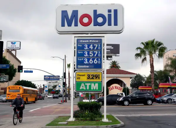 A cyclist rides by a sign at a gas station in Los Angeles posting the latest gas prices on Friday, Feb. 27, 2015. Gas prices in California soared overnight as a result of a combination of supply-and-demand factors worsened by the shutdown of two refineries that produce a combined 16 percent of the state’s gasoline.
