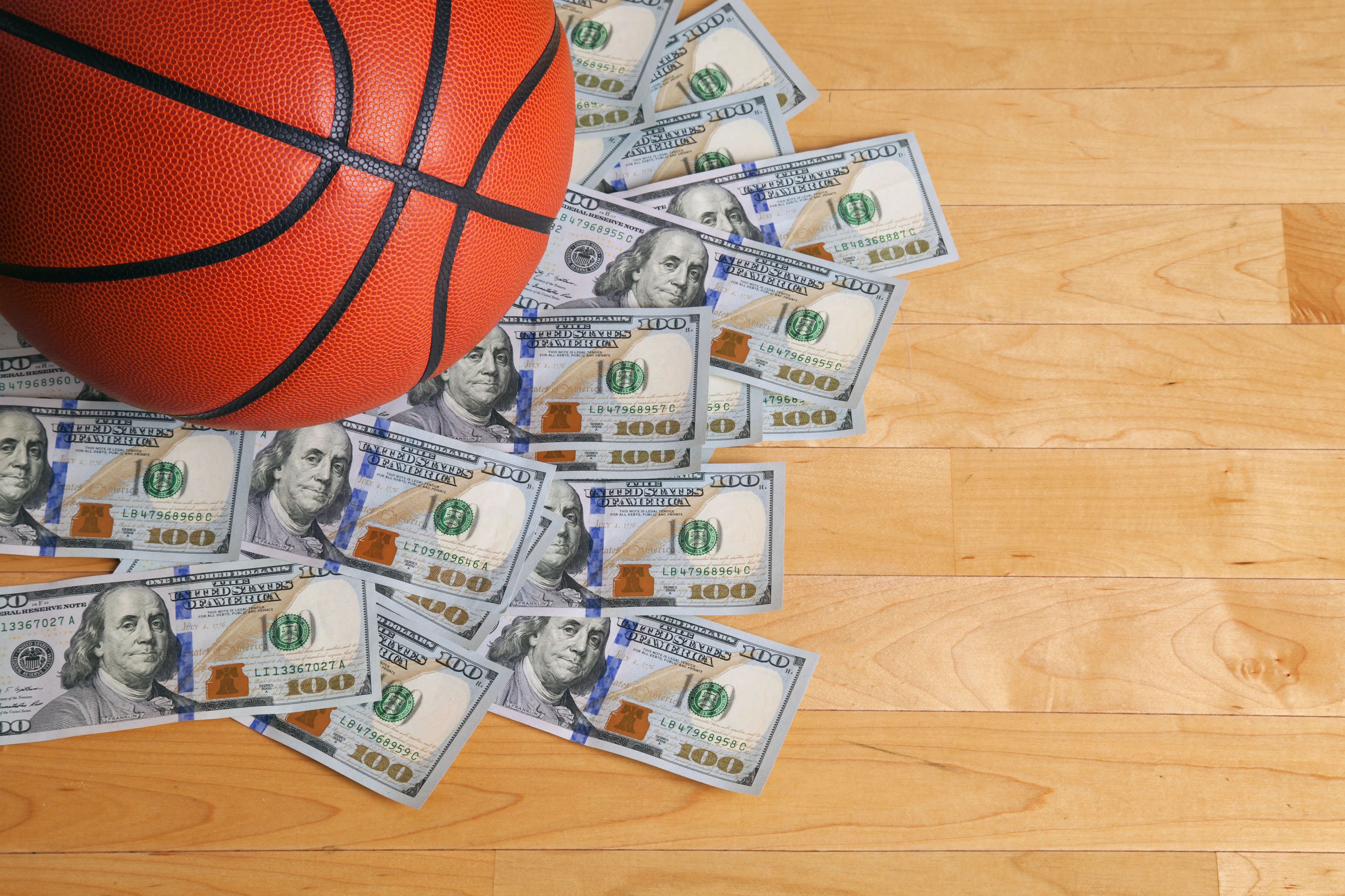 basketball on top of heap of cash