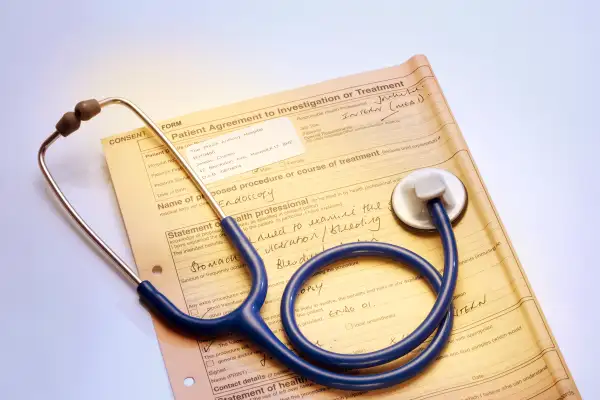 stethoscope on top of patient agreement for medical procedure form